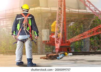 Mechanical Mason Stand Wearing Helmet And Safety Harness In Disaster Construction Zone. Mature Man. Heavy Industry. Big Broken Machinery. Professional Engineer.