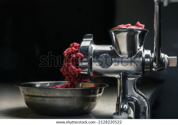 Mechanical meat grinder with\
meat
