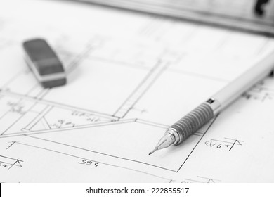 Mechanical pencil and eraser on construction plan, technical drawing