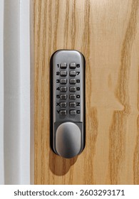 Mechanical push button digital lock on wooden door. Security code lock with a keypad. Entrance safety