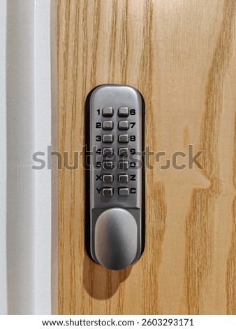 Mechanical push button digital lock on wooden door. Security code lock with a keypad. Entrance safety
