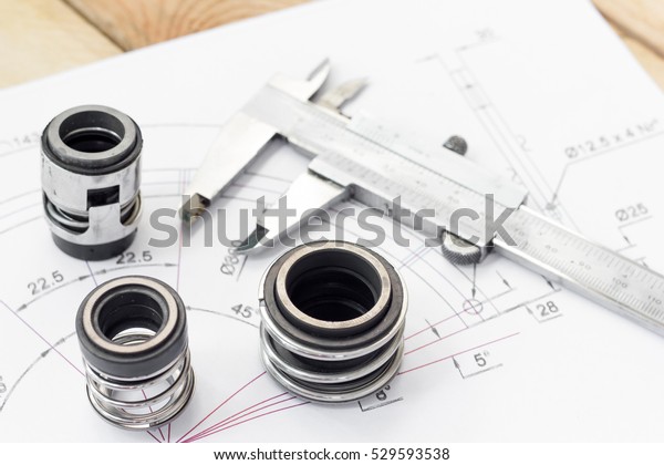 Mechanical Seals for prevent liquid leak\
for the industry with drawings on table\
working.