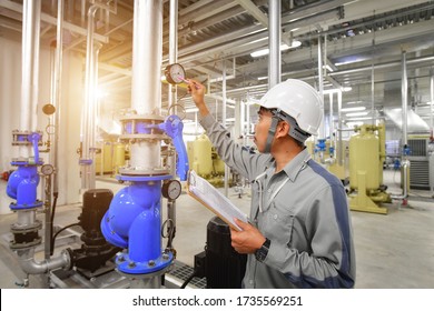 Mechanical Technician Maintenance Inspecting Heating System On  Pressure Gauge Of Industrial Air Compressor Pump System At Air Compressor Pump Room In The Factory