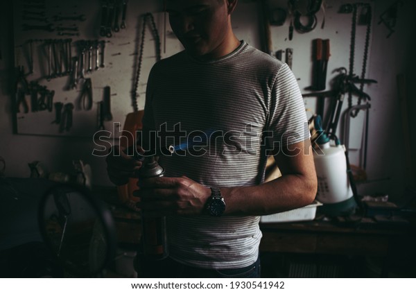 Mechanical technician and welder in the workshop with\
torch fixing parts of a\
car