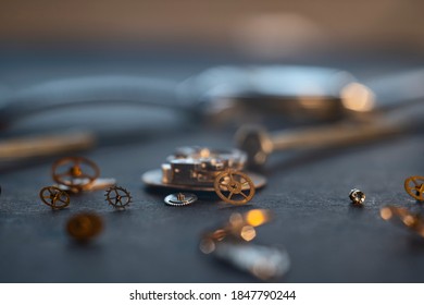 Mechanical watch assembly, watchmaker's workshop with many parts and gears
