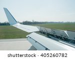 Mechanics of an airplane visible on wing while breaking during landing on runway