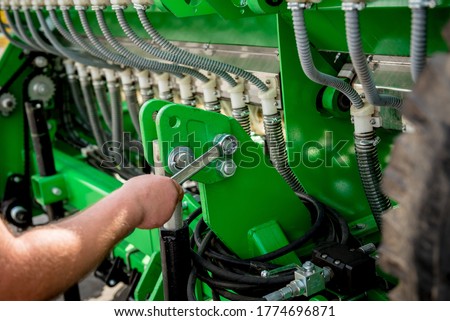 The mechanics repair combine harvester. Modern agricultural machinery