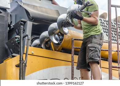 The Mechanics Repair The Yellow And Green Combine Harvester In The Farm Yard. 