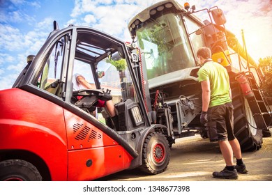 The Mechanics Repair The Yellow And Grrem Combine Harvester In The Farm Yard. 