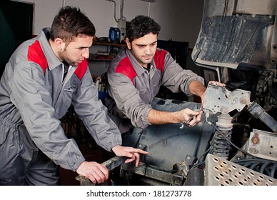 Mechanics At Work On A Truck.