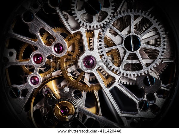 Mechanism, clockwork of a\
watch with jewels, close-up. Vintage luxury background. Time, work\
concept.