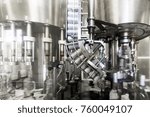 The mechanism of the screw plug feeder of the automatic capping machine.Factory for the production of alcoholic beverages.
