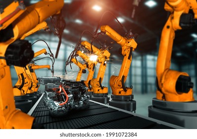 Mechanized Industry Robot Arm For Assembly In Factory Production Line . Concept Of Artificial Intelligence For Industrial Revolution And Automation Manufacturing Process .