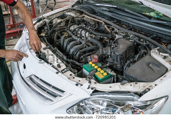Mechatronic checked the engine compartment of\
a car in the garage.\
car engine under\
hood.