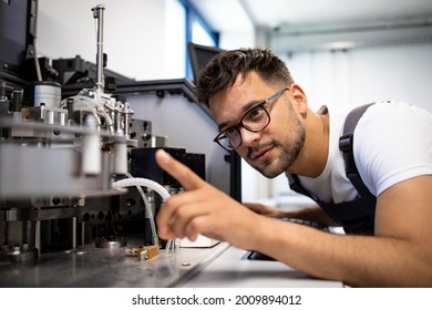 Mechatronics engineering in process. Experienced engineer working on new automated robotic machine. - Shutterstock ID 2009894012