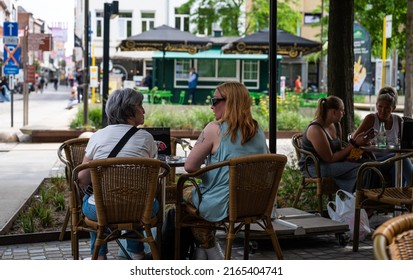 Mechelen, Antwerp Province, Belgium - 06 04 2022 - Two Ladies Talking On A Terrace In Old Town 