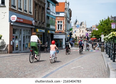 Mechelen, Antwerp Province, Belgium - 06 04 2022 - Mother And Daughter Driving The Bike In The Streets Of Old Town