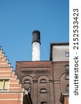 MECHELEN, Malines, Antwerp, BELGIUM, March 2, 2022, Old facades, roofs and chimney of the beer brewery Het Anker, producer of the beer Golden Carolus. High quality photo