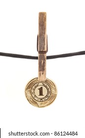 Medal, Clothespin And Rope On A White Background