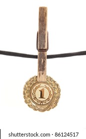 Medal, Clothespin And Rope On A White Background