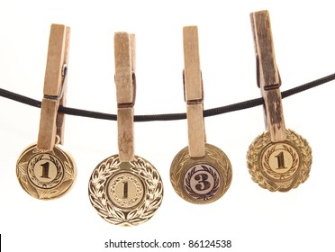 Medal, Clothespin And Rope On A White Background