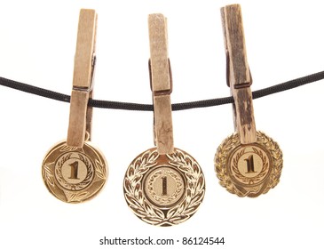 Medal, Clothespin And Rope On A White Background