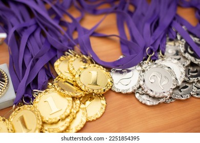 Medals for winners. Badge of distinction for sporting achievements. Many medals are on table.