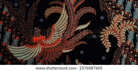 Medan, Indonesia-  October 02, 2021: Dragon motif flapping its wings on modern traditional batik cloth with black base color.
