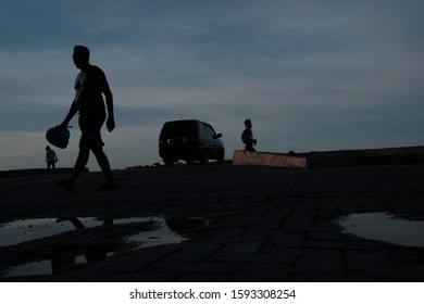 Medan, North Sumatra- October 2019: The Silhouettes Of Port Workers On One Warm Afternoon At Belawan Seaport.