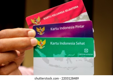 Medan, North Sumatra-Indonesia, September 14,2022: View Of Cards From Government Indonesia For The Underprivileged. Hands Hold Three  Cards 