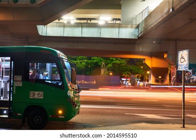 MEDELLIN, COLOMBIA - Sep 18, 2019: The Busses Passing By University Metro Station At Night In Medellin, Colombia