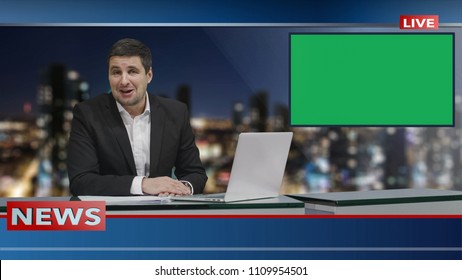 Media Broadcaster Is Sitting At A Table And Talking. Display With Green Screen. News Show Mock-up.