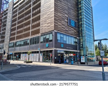 Media City, Salford Quays. UK 07 16 2022 The Co Op Convenience Store On The Corner Of An Office Or Apartment Block.