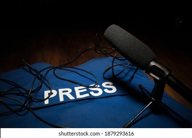 Media Journalism Global Daily News Content Concept. Blue Journalist (press) Vest In Dark With Backlight And Fog. Media Microphone On Journalist Vest. Selective Focus