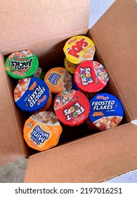 Media, Pennsylvania - April 25, 2020: A Box Holds Several Single-serve Cups Of Sweetened Kellogg's Breakfast Cereals. Sugary Foods Or Food Bank Donation Concept.