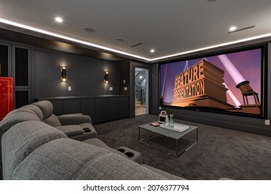 Media theatre room with dark walls grey sofa popcorn movie screen interior residential room
