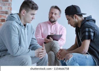 Mediation Between Two Rebel Adolescent Boys During A Cognitive Behavioral Therapy Meeting With A Psychology Specialist.