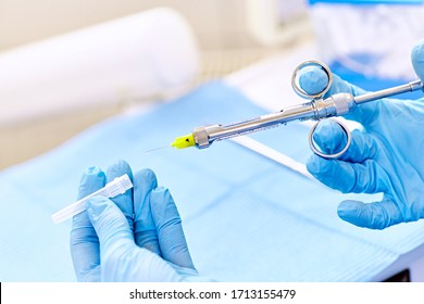 Medic hands in blue protective gloves with anaesthesia syringe.  Dental anaesthesia. 