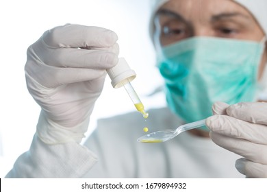 The Medic Prepares An Oral Vaccine With Pipette And Spoon