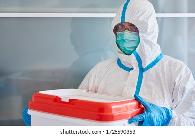 Medic In Protective Clothing During Transportation Of Organ Donation For Surgery In Clinic