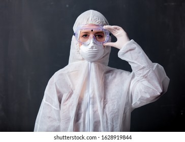 medic woman wearing protective clothing against the virus on dark background