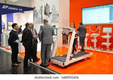 MEDICA Trade Fair, DUSSELDORF, GERMANY - NOVEMBER 2019, Delegation Of Doctors At A Medical Exhibition, Treadmill Girl.