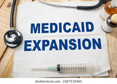 Medicaid expansion, text words typography written on paper, health and medicine concept