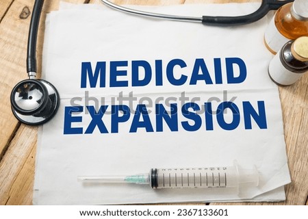 Medicaid expansion, text words typography written on paper, health and medicine concept