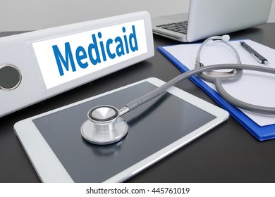 Medicaid Folder On Desktop On Table. Ipad