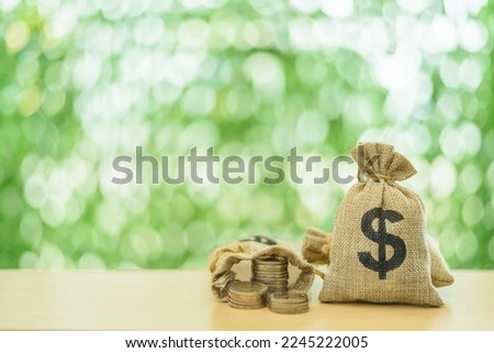 Medicaid health insurance, medical assistance, financial plans concept : US dollar bags and coins on a table. Depicting money for a health insurance program that decreases healthcare expenditures.