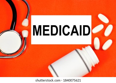 Medicaid. Text Inscription On The Background Of Medicines. The State Program Covers Medical Expenses For People With Limited Incomes.
