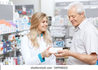 Medical Advice. Beautiful Female Customer Smiling Giving Medication To An Elderly Customer At The Drugstore Healthcare Retirement Discount Seniority Health Products Shopping Consumerism Concept  