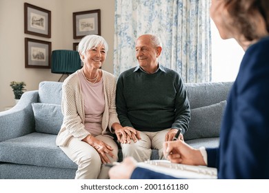 Medical Advisor During Home Visit With Senior Couple. Financial Insurance Agent In Conversation With Old Couple. Business Agent Planning With A Retired Couple Their Future Investment Opportunities.