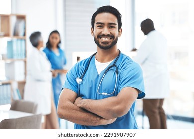 Medical, arms crossed doctor with portrait of man for healthcare, surgery and happy. Smile, medicine and confident with male nurse standing in hospital for wellness, cardiology and expert - Powered by Shutterstock